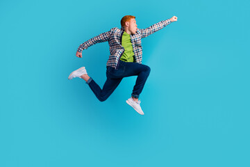 Full length profile photo of cheerful man run look empty space isolated on turquoise color background