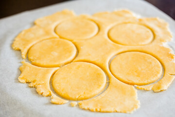 pastry-making with this captivating image featuring a close-up of perfectly cut shortcrust dough circles in a kitchen setting
