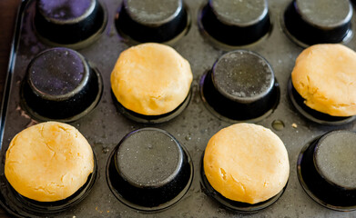 Obraz na płótnie Canvas Elegance in Baking: Close-Up of Shortcrust Dough Formed in Tart Shell