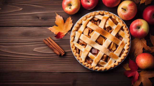 Homemade autumn apple pie with fall leaves on a wooden table u with copy space with text. thanksgiving concept