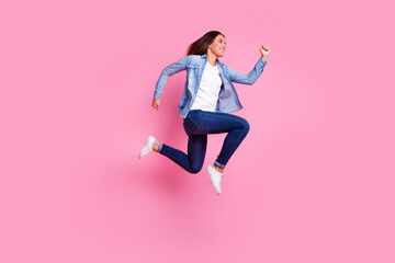 Carefree woman jumping against pastel background