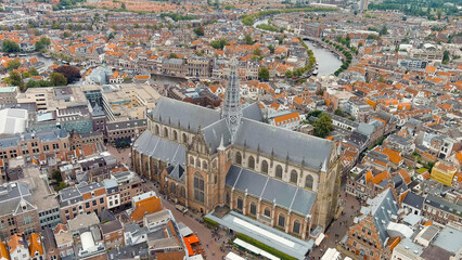 Haarlem, Netherlands. The Church of St. Bavo is a Gothic temple. Panoramic view of Haarlem city center. Cloudy weather during the day. Summer, Aerial View - obrazy, fototapety, plakaty