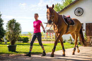  girl with horse in stable