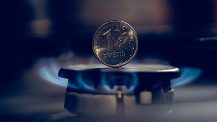 a ruble coin on a gas burner - obrazy, fototapety, plakaty