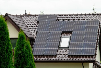 Fototapeta premium Historic farm house with modern solar panels on roof and wall