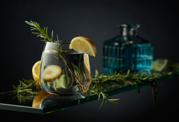 Cold refreshing drink with lemon and rosemary.