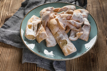 Faworki decorated with powdered sugar.