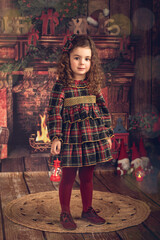 Girl in a Christmas decoration with a lantern in her hand
