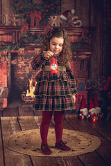 Girl in a Christmas decoration with a lantern in her hand