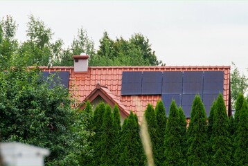 Historic farm house with modern solar panels on roof and wall