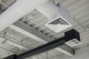 Two ventilation duct systems with grilles under ceiling in commercial building. Supply and exhaust - obrazy, fototapety, plakaty