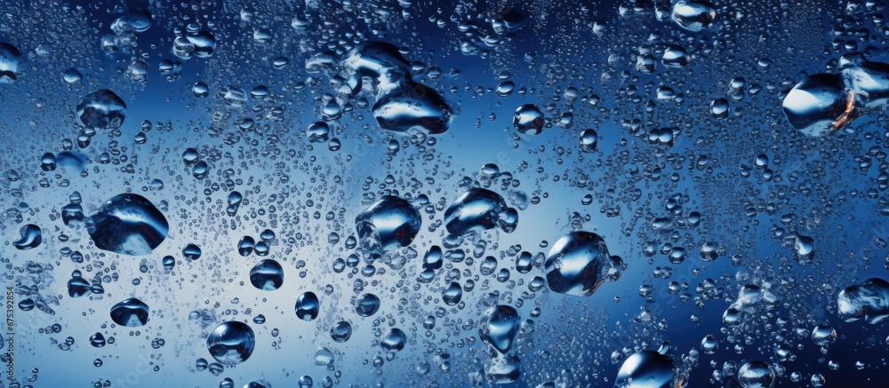 Poster the blue water splashed against the glass in a mesmerizing pattern creating a beautiful texture and 