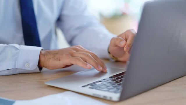 Lawyer sending emails on a laptop while working in an office. Closeup of a busy advocate or legal assistant researching online. Searching for information while preparing for a case