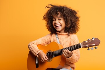 cheerful african american girl playing acoustic guitar isolated on yellow - Powered by Adobe