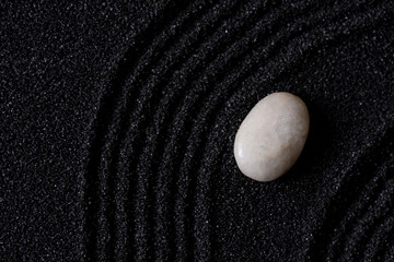 Zen Garden with White stone on Black Sand Wave Pattern in Japanese stye, Rock Sea Stone on Sand texture with the wave parallel lines pattern,Harmony,Meditation,Zen like concept
