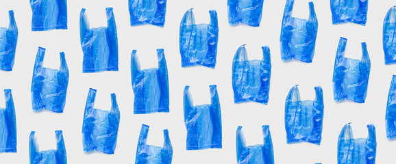 Top view pattern from blue plastic bags, wide banner. Single-use polythene packet, Eco trend to...