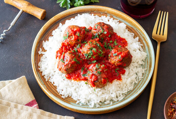 Rice with meatballs in tomato sauce. Italian food.