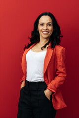 Portrait of young Brazilian businesswoman over red background