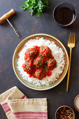 Rice with meatballs in tomato sauce. Italian food.