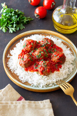 Rice with meatballs in tomato sauce. Italian food.