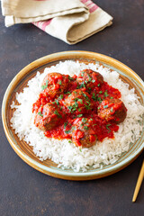 Rice with meatballs in tomato sauce. Italian food.