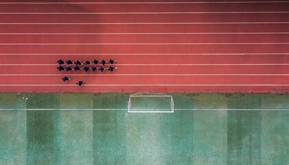 Aerial view of a running track with a group of runners.