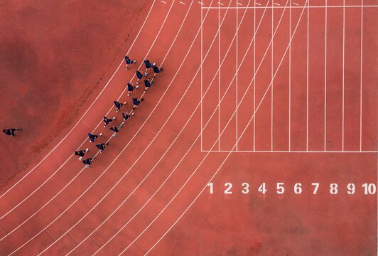 Aerial View Of A Running Track With A Group Of Runners.