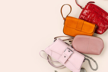 Various leather handbags. Fashion women's handbags on beige background. Stylish accessories....