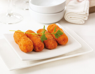 Traditional Spanish homemade croquettes or croquetas on a white plate. Tapas food.
