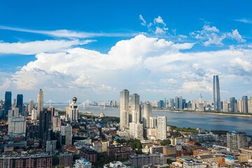 Aerial view of a vibrant metropolitan cityscape featuring a cluster of buildings: Wuhan