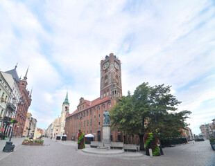 Fototapeta premium Toruń's Gothic town hall with cloudy sky in Poland