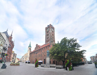 Toruń's Gothic town hall with cloudy sky in Poland
