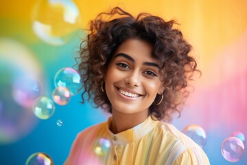 Fototapeta premium happy smiling indian woman on colorful background with rainbow soap balloon with gradient