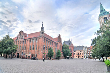 Toruń's Gothic town hall with cloudy sky in Poland