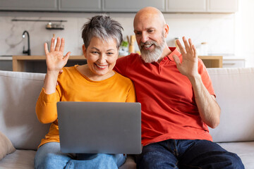Fototapeta premium Video Call. Happy Senior Spouses Teleconferencing With Laptop At Home