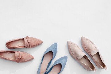 Various women’s flat shoes in pastel color. Fashion ballet shoes and loafers. Stylish autumn or spring accessories.