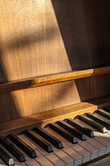 an old piano with keys in the sunbeaming sunlight
