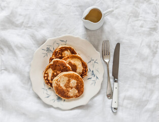 Banana-curd pancakes - delicious breakfast, snack on a light background, top view