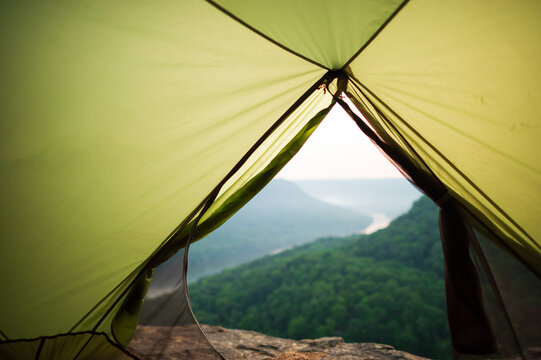 Looking out from inside an empty green tent at a river gorge in Tennessee