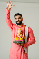Young Indian man with Lord Ganesha , Celebrating Ganesha festival