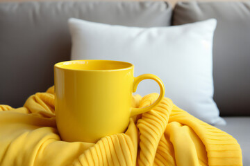 Fototapeta na wymiar breakfast with coffee in bed. Yellow coffee mug, cozy yellow blanket at a sofa in a living room with big bright window. Home modern interior. 