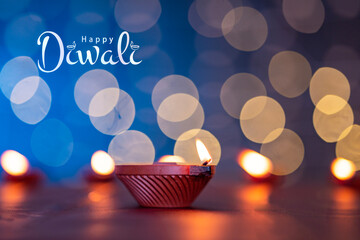 Happy Diwali background, Diwali Diya lit isolated on bokeh light
