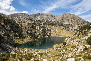 Naklejka na ściany i meble Beautiful landscape of the natural park of Aigestortes y Estany de Sant Maurici, Pyrenees valley with river and lake