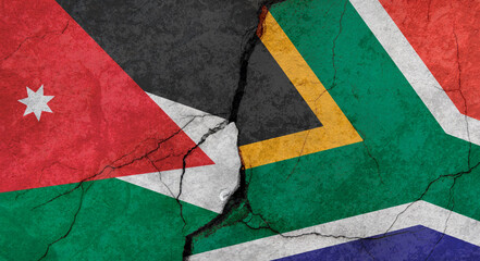 Jordan and South Africa flags, concrete wall texture with cracks, grunge background, military conflict concept