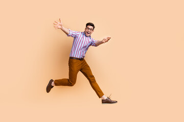 Fototapeta na wymiar Full length photo of friendly nice man wear trendy clothes open hands hugging you walking empty space isolated on beige color background