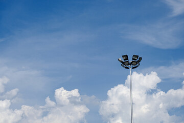 spotlight pole with cloud blue sky and copy space