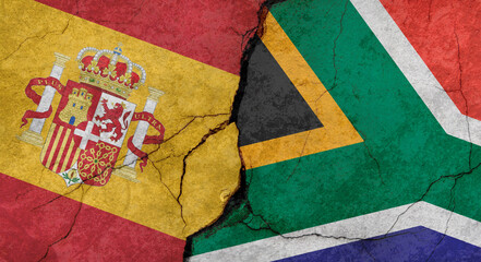 Flags of Spain and South Africa, texture of concrete wall with cracks, grunge background, military conflict concept