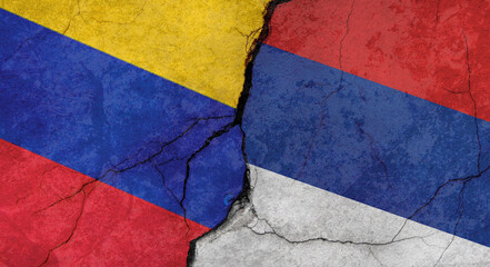 Venezuela and Serbia flags texture of concrete wall with cracks, grunge background, military conflict concept