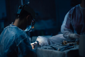 surgeon operating on patient in operating room close up, surgical operation - Powered by Adobe
