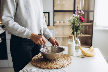 Close up of a woman prepares a banana muffin with berries for breakfast. healthy homemade food...